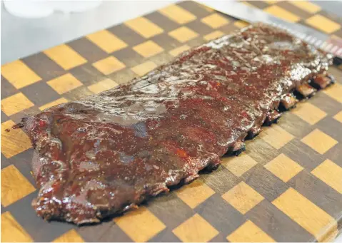  ?? Marvin Pfeiffer / Staff photograph­er ?? A finished rack of champion barbecue cook Corey Flores’ St. Louis style pork ribs used the same recipe that was good enough to take first place out of more than 300 cooks in the 2018 San Antonio Stock Show &amp; Rodeo Bar-B-Que Cook-Off.