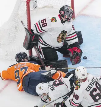  ?? THE CANADIAN PRESS ?? Edmonton Oilers’ Connor McDavid is stopped by Chicago Blackhawks goalie Corey Crawford during the third period in Edmonton on Saturday.