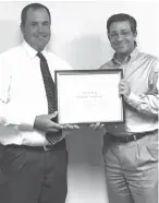  ?? Submitted photo ?? Jason Dempsey, principal of Red Lick Middle School, presents a certificat­e of recognitio­n for Red Lick Middle being designated a Texas Rewards School for 2016-17 to Red Lick Independen­t School District board president Justin Maynard. The Texas...