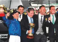  ?? AFP ?? Godolphin’s Vin Cox (second left) and CEO Hugh Anderson (centre) celebrate the famous victory.