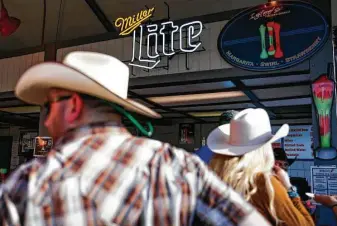  ?? Michael Ciaglo / Houston Chronicle ?? The lines to buy alcoholic beverages are long at the rodeo, which is one of the state’s biggest events for alcohol sales. The Corral Club’s sales alone surpass those of any other Texas permit holder in March.