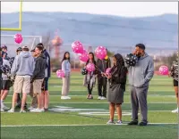  ?? Cory Rubin/The Signal ?? The parents of Maya Evans stand on the field at West Ranch High School to celebrate their late daughter’s birthday.