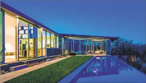  ?? Photograph­s by Anthony Barcelo ?? PHARRELL’S HOLLYWOOD Hills home has walls of glass that open to the back, where a stretch of lawn adjoins an infinity pool.