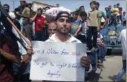  ?? COURTESY OF MUSTAFA ALABDULLAH VIA AP ?? This image courtesy of Mustafa Alabdullah, an activist and resident of Idlib, shows a protester holding a placard, in Harim, a town in Idlib province, Syria, Friday.