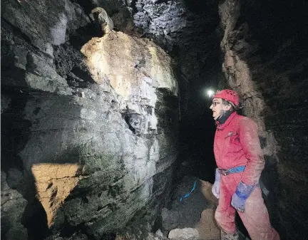  ?? PIERRE OBENDRAUF ?? Spelunker Daniel Caron examines rock formations in a cavern system beneath a park in St-Léonard on Friday. Caron and Luc Le Blanc discovered the 250-metre-long cavern in October and experts believe it has been in existence for at least 15,000 years.