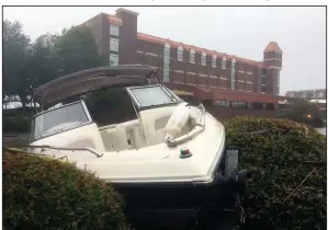  ?? AP/ALLEN G. BREED ?? A speedboat sits wedged in bushes in the parking lot of a waterfront hotel Friday in New Bern, N.C. Wind and rain from Florence caused the Neuse River to rise, swamping the city.