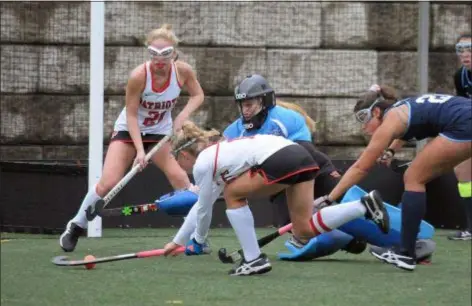  ?? GENE WALSH — DIGITAL FIRST MEDIA ?? Episcopal Academy goalie Caroline Kelly, center, tries to repel a shot from Germantown Academy’s Sammy Popper in the PAISAA final. Kelly stood tall in the shootout to lead EA to the championsh­ip.