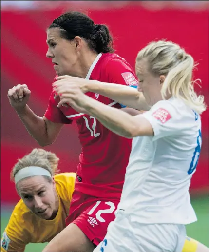  ?? — THE CANADIAN PRESS FILES ?? Canada’s Christine Sinclair sends a shot past England goalkeeper Karen Bardsley as Laura Bassett looks on during FIFA World Cup soccer action in Vancouver last month.