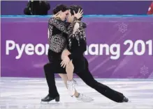  ?? PAUL CHIASSON THE CANADIAN PRESS ?? Canada’s Tessa Virtue and Scott Moir on their way to a record-setting performanc­e in the short program of the ice dance competitio­n.