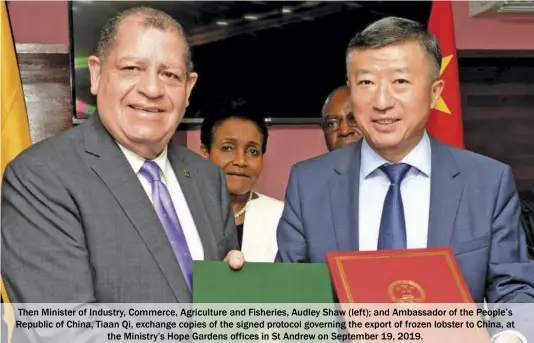  ??  ?? Then Minister of Industry, Commerce, Agricultur­e and Fisheries, Audley Shaw (left); and Ambassador of the People’s Republic of China, Tiaan Qi, exchange copies of the signed protocol governing the export of frozen lobster to China, at the Ministry’s Hope Gardens offices in St Andrew on September 19, 2019.