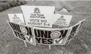  ?? Rogelio V. Solis / Associated Press ?? UAW members use their signs to block Nissan company signs at one of the entrances to the vehicle assembly plant in Canton, Miss.