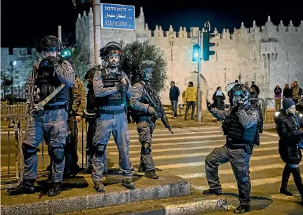  ?? PHOTO: GETTY IMAGES ?? Israeli police officers stand watch outside the Damascus Gate in the Old City in Jerusalem yesterday. Tension is high in the city after United States President Donald Trump’s announceme­nt recognisin­g Jerusalem as the capital of Israel.