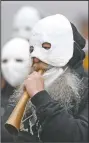  ?? (AP Photo/Petr David Josek) ?? A participan­t blows a horn during the procession.