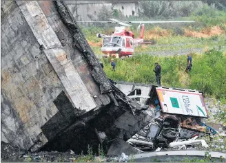  ?? AP PHOTO ?? Rescues work among the debris of the collapsed Morandi highway bridge in Genoa, Tuesday.