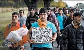  ?? ANDREJ ISAKOVIC/GETTY-AFP ?? Hundreds of migrants stranded in Serbia set off on foot from Belgrade toward the border with Hungary on Tuesday to protest its closure for most people trying to reach the European Union.