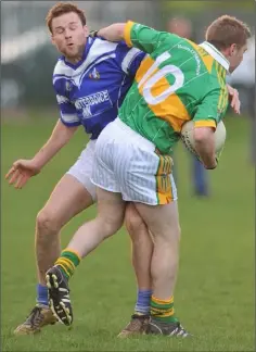  ??  ?? Mick Fanning of Naomh Mairtin tries to stop Barry Mackin of Sean O’Mahony’s from advancing.