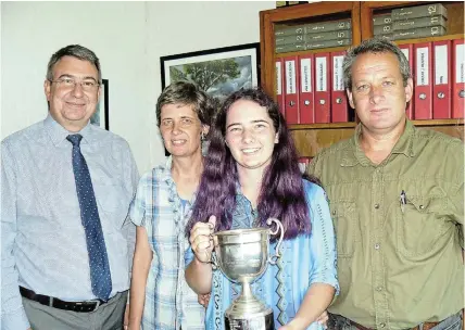  ?? Pictures: SID PENNEY ?? TOP SPOT: PJ Olivier High School matric pupil in 2023, Carissa Henning, holds the trophy she was awarded as the top pupil in the 2023 National Senior Certificat­e examinatio­ns at the school. Congratula­ting her are, from left, PJ Olivier principal Joubert Retief and her parents Carmen and Christo Henning. Carissa will enrol for a BSc degree at Rhodes University in 2024 with zoology and music as subjects. PJ Olivier’s 42 matrics achieved an 85,7% pass rate.