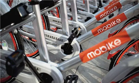  ??  ?? A cycle in the park: A file photo of Mobike’s bicycles with snazzy orange wheels. Food delivery giant Meituan has recently agreed to acquire the startup.