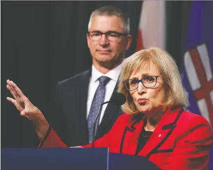  ?? GAVIN YOUNG ?? Former Saskatchew­an finance minister Janice Mackinnon explains her panel’s report on Alberta’s finances in Calgary Tuesday as Alberta Finance Minister Travis Toews looks on. Toews wouldn’t say how many of the panel’s 26 recommenda­tions would be enacted by the UCP.