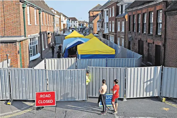  ??  ?? Forensic work is conducted behind police barriers in Rollestone Street, outside John Baker House Sanctuary Supported Living accommodat­ion in Amesbury, Wilts, where Dawn Sturgess, one of the victims, has been living