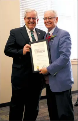  ?? ANGELA SPENCER/THREE RIVERS EDITION ?? State Sen. Eddie Joe Williams, R-Cabot, left, presents outgoing ASU-Beebe Chancellor Eugene McKay with a citation commending McKay on his 50 years of service to the school.