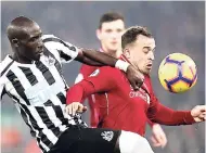  ?? AP ?? Newcastle’s Mohamed Diame (left) and Liverpool’s Xherdan Shaqiri battle for the ball during the English Premier League match at Anfield Stadium, Liverpool yesterday. The hosts won 4-0.