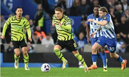  ?? ?? Martin Ødegaard breaks away from Brighton’s Julio Enciso during Arsenal’s 3-0 win. Photograph: Stuart MacFarlane/Arsenal FC/Getty Images