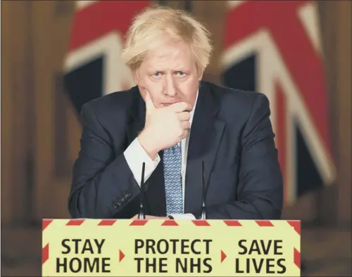  ?? PICTURES: TOLGA AKMEN/ PA ?? ARMY PLANS: Prime Minister Boris Johnson takes a question during a media briefing in Downing Street, as he enlisted the military to help bring the pandemic under control. He said the Army would help distribute the jab across the UK and promised that every care home resident in England will be offered the vaccine by the end of this month.