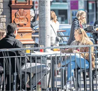  ?? POSTMEDIA NEWS ?? People sit at a restaurant patio to take advantage of sunny weather in Ottawa.