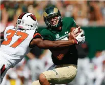  ?? Associated Press ?? n Oregon State linebacker Kee Whetzel, left, tries to tackle Colorado State quarterbac­k Nick Stevens as he looks to pass the ball in the second half of an NCAA college football game Saturday in Fort Collins, Colo.