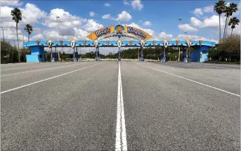  ?? Associated Press ?? ■ Lanes leading to the parking plaza entrance of Walt Disney World’s Magic Kingdom sit empty during its closure in response to the coronaviru­s pandemic in Orlando. From Cape Cod to California, festivals are being canceled, businesses in tourist havens are looking at empty reservatio­n books, and people who have been cooped up through a dismal spring are worrying summer will bring just more of the same.