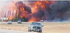  ?? JONATHAN HAYWARD THE CANADIAN PRESS FILE PHOTO ?? A giant fireball is seen as a wildfire rips through the forest in May 2016, 16 kilometres south of Fort McMurray, Alta.