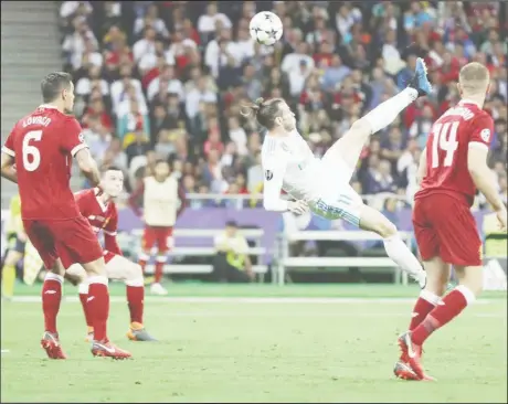  ??  ?? Gareth Bale’s astonishin­g bicycle kick gave Real Madrid a 2-1 lead in yesterday’s Champion’s League final. Bale netted once more to become the first substitute player to score twice in a Champions League final.