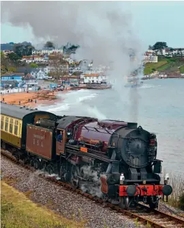  ?? CHRIS SLACK PHOTOGRAPH­Y/ DSRRC ?? Above: Peter Best’s USATC S160 No. 2253 Omaha,
representa­tive of a class that ran on the line during preparatio­ns for D-Day in 1944, heads a Dartmouth Steam Railway service past Goodringto­n on April 29.