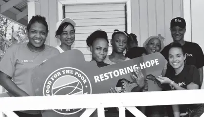  ?? ?? From left: Marsha BurrellRos­e, developmen­t and marketing manager, Food For The Poor hands over the keys to a new house to 34-year-old mother of three from Linstead, St Catherine, Kimoy Buchanan (second left) and her children, Antionette Stephenson, Akayla Bennett and Ashanae Brown. The house was built on lands adjacent to her mother’s house who is also a recipient of a house from Food For The Poor. Also photograph­ed is Michelle Gordon of BossMom (back right) Rachael Bravo (front right) and Karel Ellington (back left) of Proven.