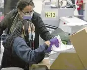  ?? Irfan Khan Los Angeles Times ?? ELECTION workers scan ballots Friday in Downey. Officials say they’ve been working around the clock.