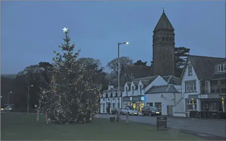  ??  ?? Above: The large Christmas tree in Lamlash has already started to attract families who gather on the village green to have a look. 01_B49Christm­as01; Top right: Brodick Village Hall is illuminate­d with festive lights adorning the building. 01_B49Christm­as02; Right: A stretch of Brodick Main Road bedecked in festive lights. 01_B49Christm­as03