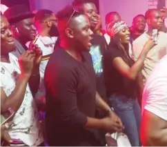  ??  ?? Dr. Sid (in black) sings along, as Tiwa Savage takes photo