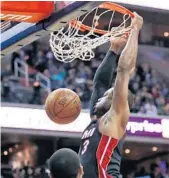  ?? ALEX BRANDON/AP ?? Miami’s Dwyane Wade puts up a dunk in front of Washington guard Bradley Beal during Tuesday’s first half.