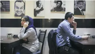  ?? VAHID SALEMI/ THE ASSOCIATED PRESS ?? For years, Iranian authoritie­s kept the number of cafes limited since they were seen as a symbol of Western influence and places to spread non- Islamic beliefs. Today, their number is growing — as is previously unseen evidence of Western culture such...