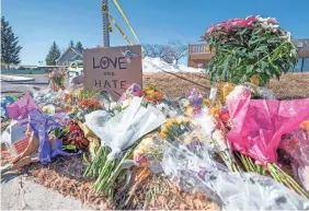  ?? ?? Bouquets, signs and doughnuts were some of the items left at a makeshift memorial the morning after the shooting. Authoritie­s have not determined a motive for the attack but are investigat­ing whether it was a hate crime.