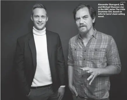  ?? AP PHOTO ?? Alexander Skarsgard, left, and Michael Shannon star in the AMC series The Little Drummer Girl, based on John le Carre’s best-selling novel.