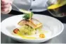  ??  ?? Pan-fried salmon and scallops served with crushed potato