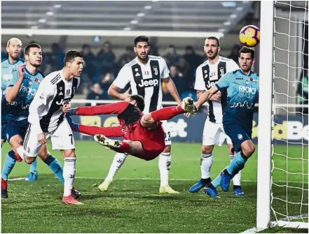  ?? — AP ?? Scoring machine: Juventus’ Cristiano Ronaldo (third from left) scoring his side’s second goal during the Serie A match against Atalanta on Wednesday.