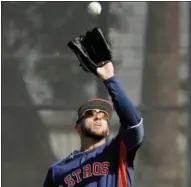  ?? ASSOCIATED PRESS ?? Houston Astros outfielder George Springer catches a pop fly during spring training baseball practice Monday in West Palm Beach, Fla.