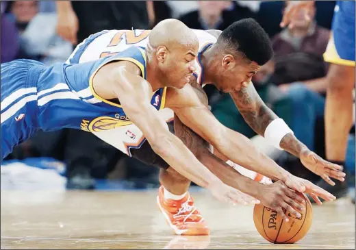  ??  ?? Golden State Warriors’ Jarrett Jack (left), and New York Knicks’ Iman Shumpert dive for a loose ball during the first half of an NBA basketball game on Feb 27, in New York. (AP)