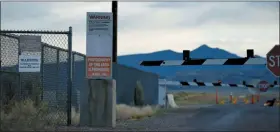  ?? JOHN LOCHER — THE ASSOCIATED PRESS ?? Signs warn about trespassin­g at an entrance to the Nevada Test and Training Range near Area 51 outside of Rachel, Nev.