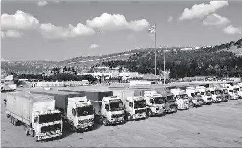  ?? AP PHOTO/GHAITH ALSAYED ?? Trucks loaded with UN humanitari­an aid for Syria following a devastatin­g earthquake reach the Bab alHawa border crossing with Turkey, Idlib province, Syria, on Friday.