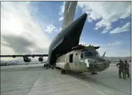  ?? DEPARTMENT OF DEFENSE VIA AP ?? In this image provided by the Department of Defense, a Ch-47chinook from the 82nd Combat Aviation Brigade, 82nd Airborne Division is loaded onto a U.S. Air Force C-17 Globemaste­r III at Hamid Karzai Internatio­nal Airport in Kabul, Afghanista­n, Saturday, Aug, 28, 2021.