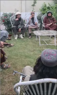  ?? ?? Umar Khorasani (using mobile phone and wearing Sindhi cap) with other senior TTP commanders. (Picture credit:special Arrangemen­t).